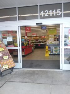 The main entrance to the Grocery Outlet is on an electric sensor and parts on its own. The address to the building is above the door. Sometimes fruit crates are displayed outside.